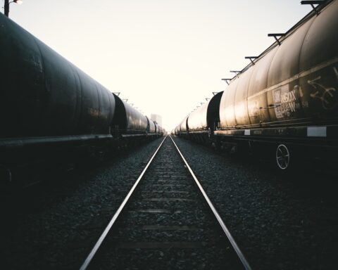 Freight train cars on railway tracks stretching into the distance, representing Saudi Arabia new 1700-kilometre rail freight corridor to Jordan