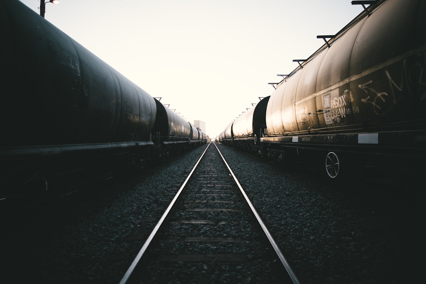 Freight train cars on railway tracks stretching into the distance, representing Saudi Arabia new 1700-kilometre rail freight corridor to Jordan