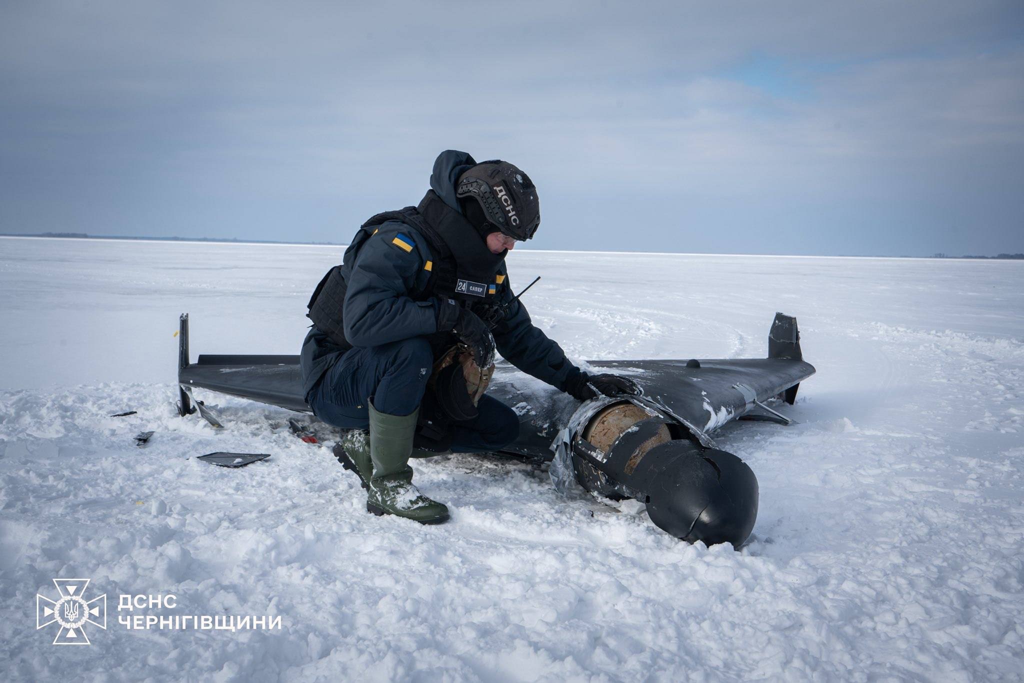 A Ukrainian emergency services worker examines the wreckage of a downed Shahed drone in Chernihiv Oblast, February 2026. Ukraine has intercepted tens of thousands of such drones since 2022. Photo: State Emergency Service of Ukraine / CC BY 4.0