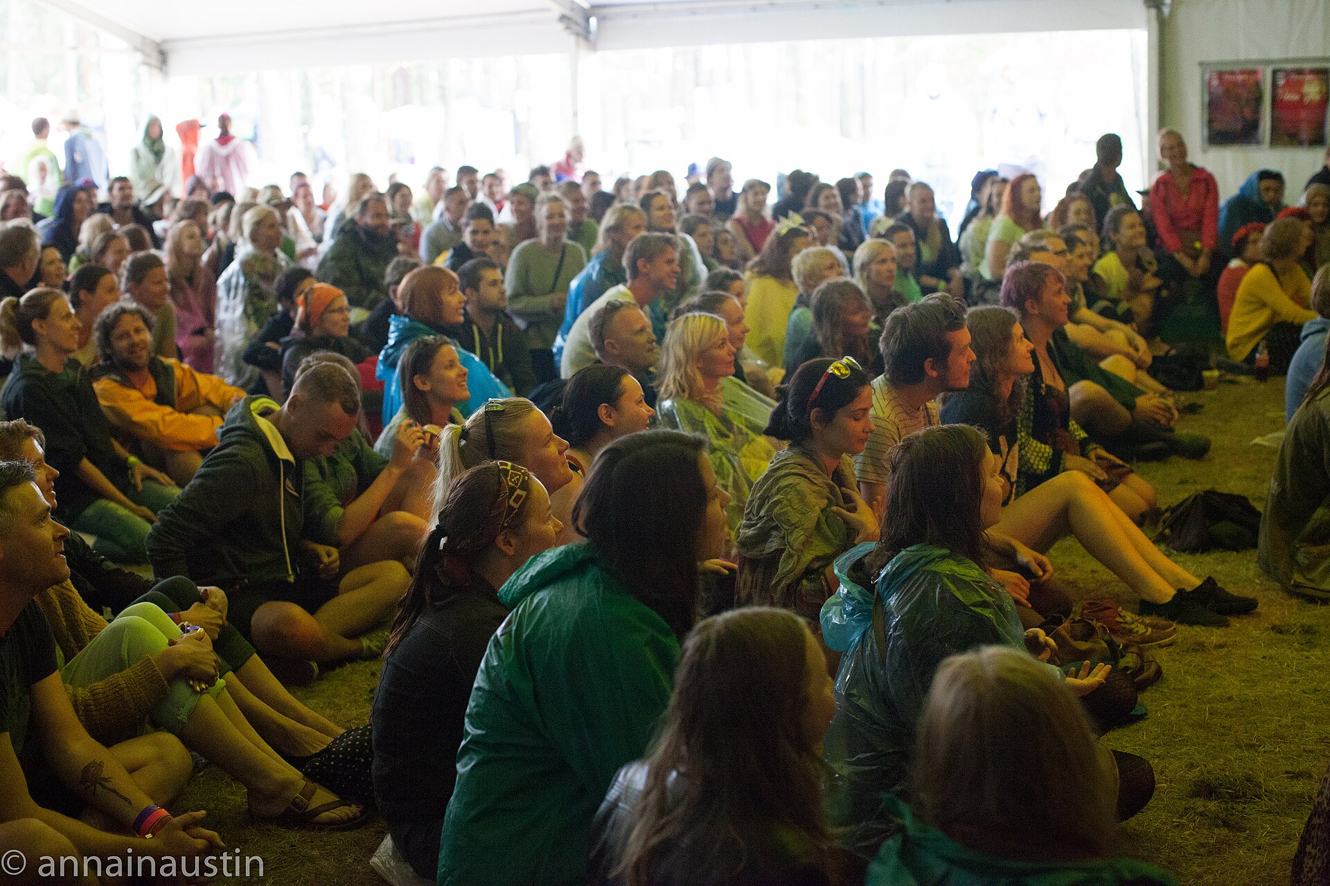 Music festival crowd with colourful stage lights at night