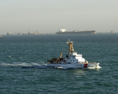 U.S. Coast Guard cutter patrols near a super tanker loading crude oil at the Al Basrah Oil Terminal in the Arabian Gulf