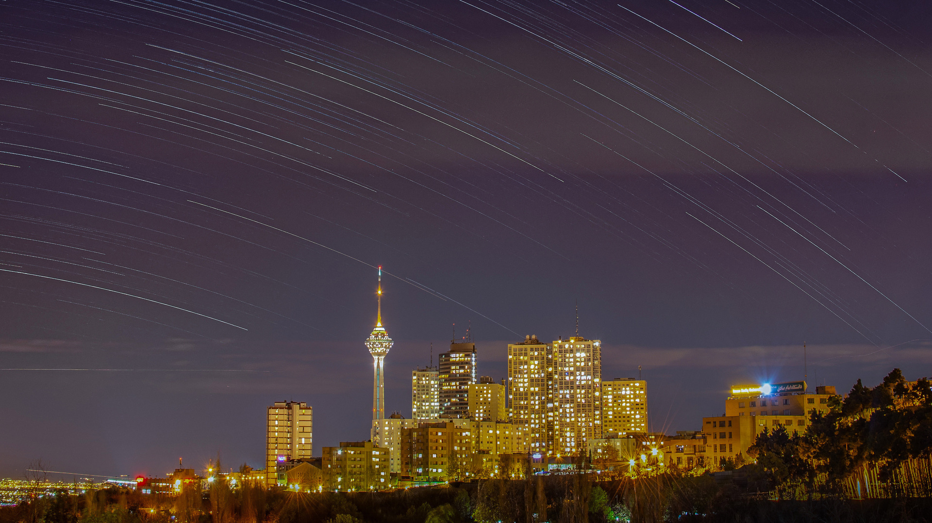 Tehran illuminated at night with the Milad Tower dominating the skyline, a city of 15 million people that could be plunged into darkness if the United States strikes Iranian power plants. Photo: Wikimedia Commons / CC BY-SA 4.0