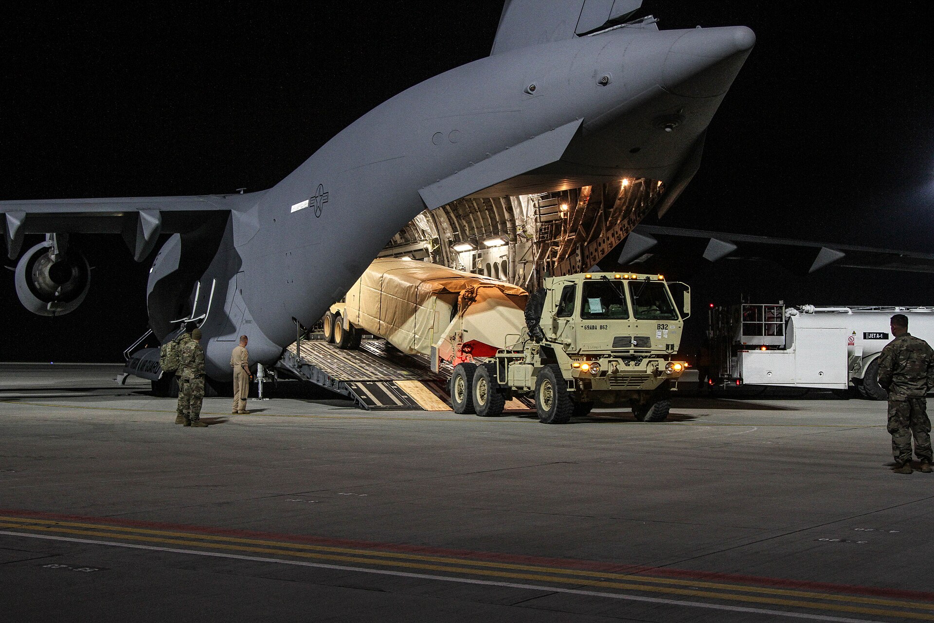 A US Army THAAD battery component being loaded onto a C-17 Globemaster transport aircraft at night for redeployment. Photo: US Army / Public Domain