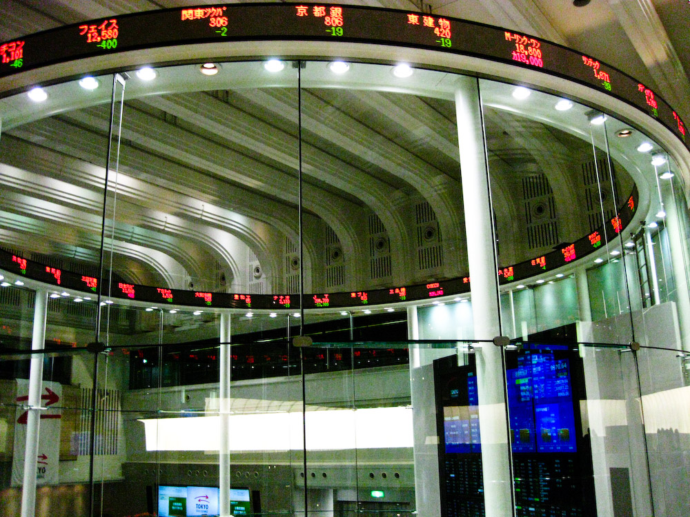 The Tokyo Stock Exchange market centre with electronic tickers displaying share prices during the March 2026 selloff. Photo: Wikimedia Commons / CC BY 2.0