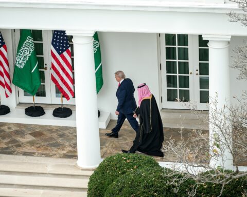 President Donald Trump and Crown Prince Mohammed bin Salman walking at the White House South Portico with US and Saudi flags, November 2025. Photo: White House / Public Domain