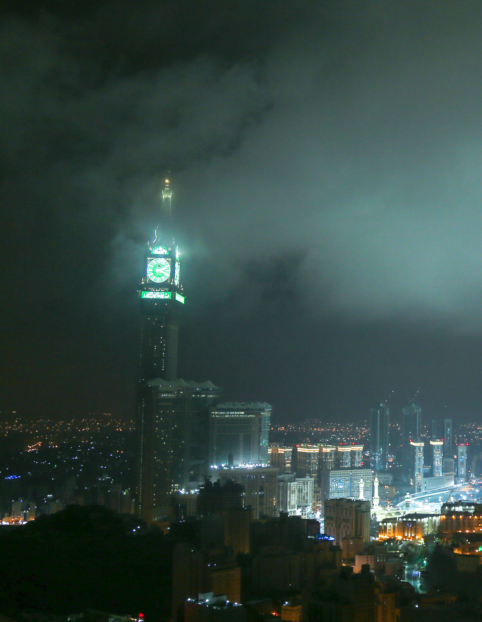 The Abraj Al-Bait Clock Tower illuminated at night overlooking the city of Makkah