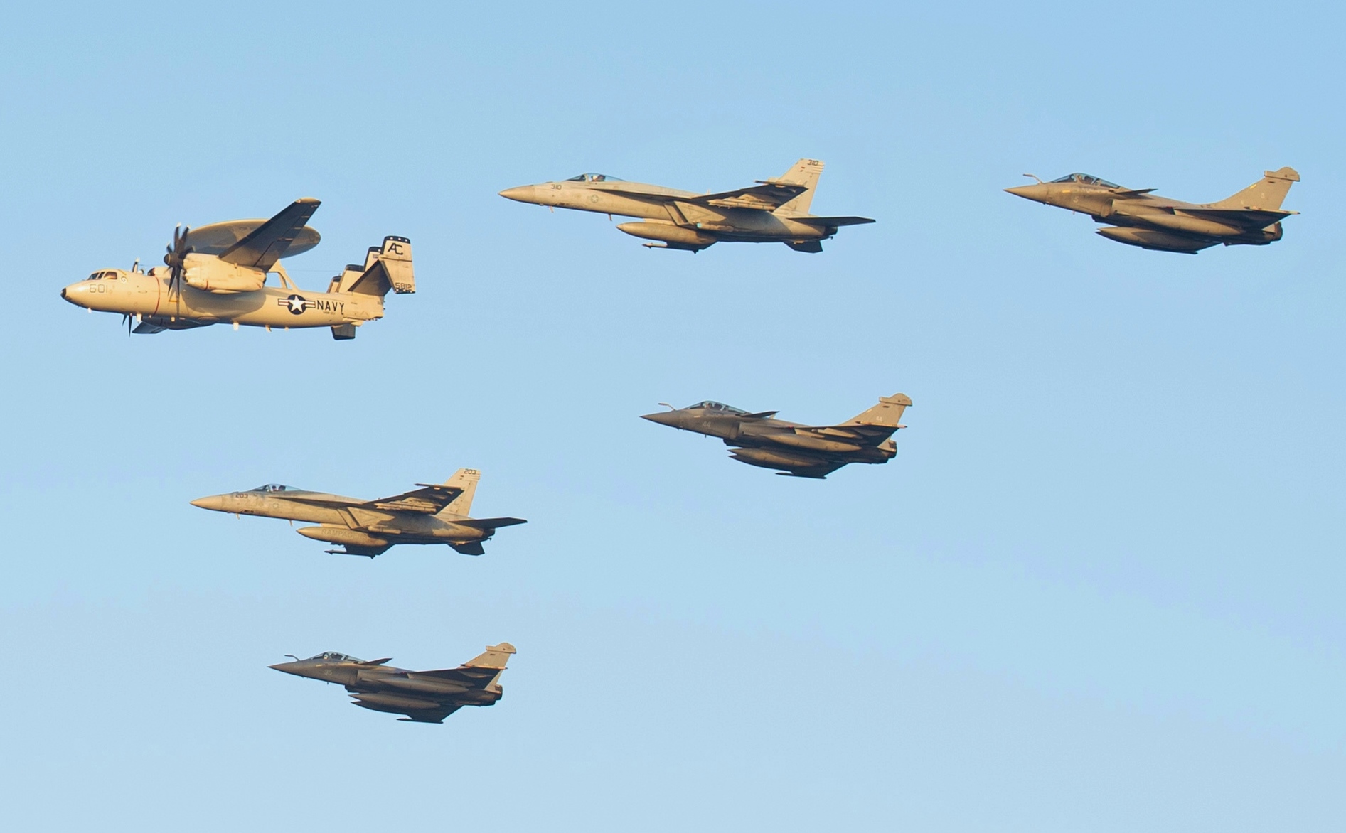 US Navy and French Navy aircraft including Rafale fighters and Super Hornets flying in formation over Arabian Sea during joint carrier operations. Photo: US Navy / Public Domain