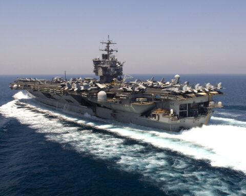 US Navy aircraft carrier USS Enterprise transiting the Persian Gulf during flight operations with fighter jets on deck