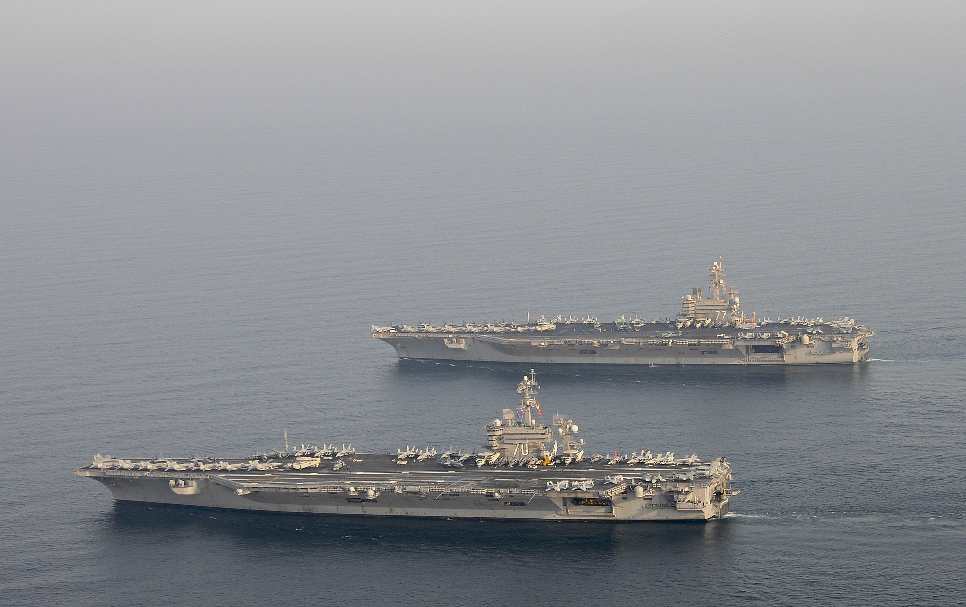 Two US Navy aircraft carriers operating in the Persian Gulf near the Strait of Hormuz during the 2026 Iran war. Photo: US Navy / Public Domain