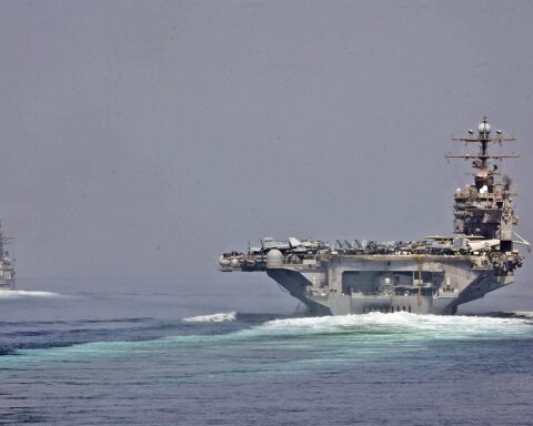 U.S. Navy aircraft carrier and guided-missile cruiser transit the Strait of Hormuz, the vital shipping lane now closed amid the 2026 Iran war. Photo: U.S. Navy / Public Domain