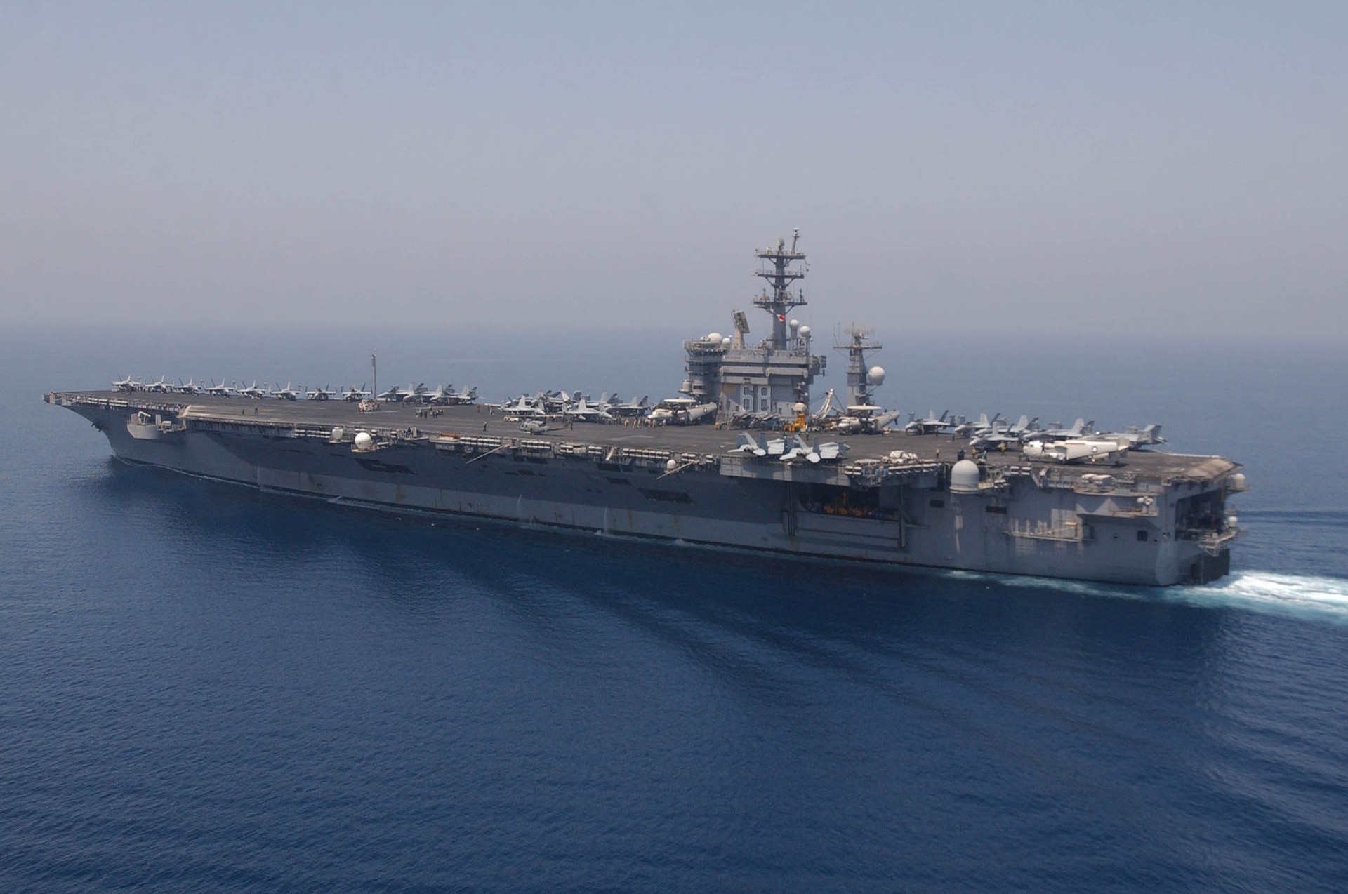 The aircraft carrier USS Nimitz underway in the Persian Gulf with fighter jets visible on its flight deck
