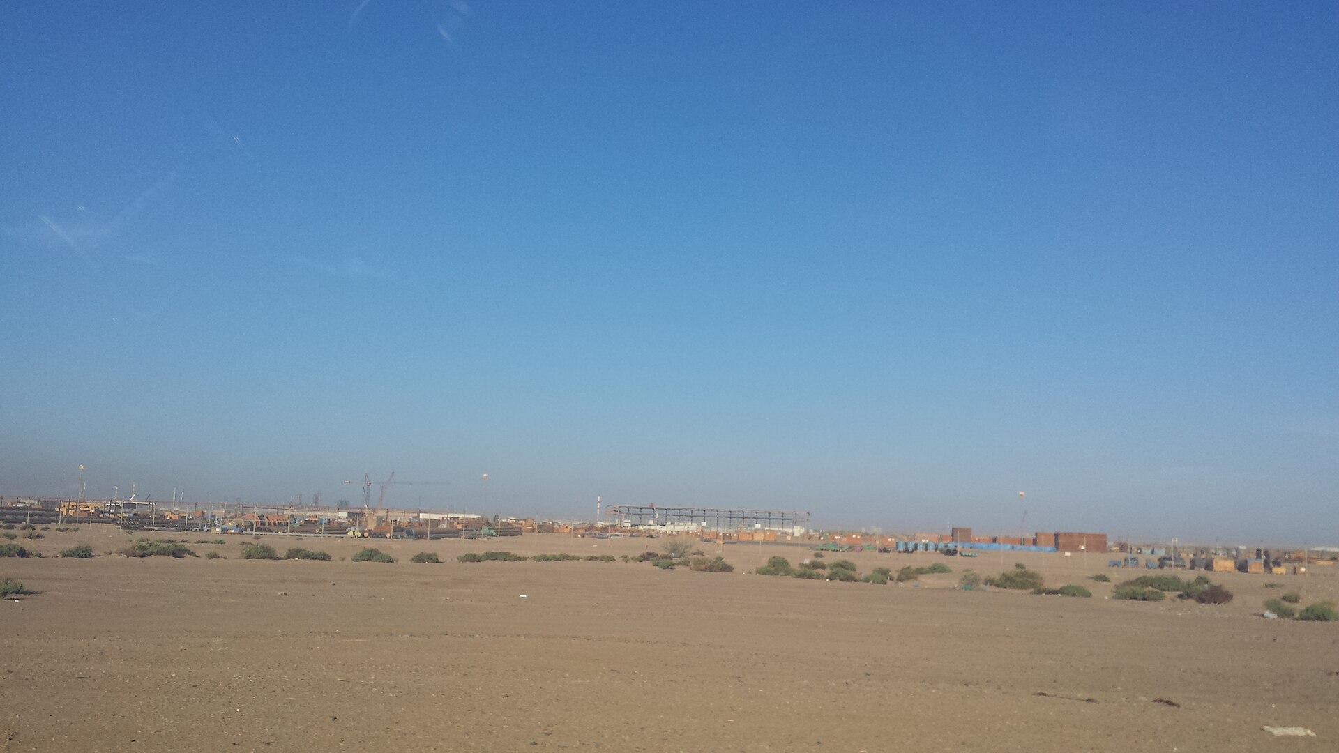 Yanbu Al Sinaiyah industrial zone on Saudi Arabia Red Sea coast with port cranes and oil infrastructure