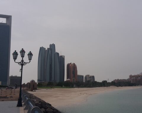 Abu Dhabi Corniche skyline with ADNOC headquarters tower on the left, UAE