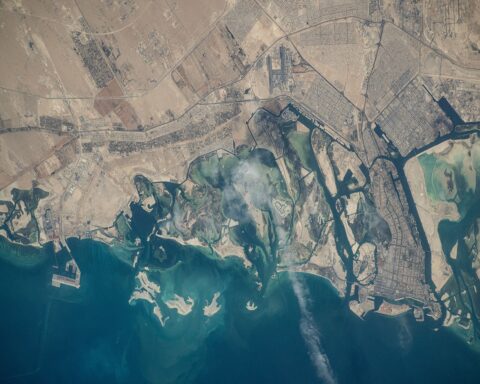 Abu Dhabi western industrial coastline photographed from the International Space Station showing port infrastructure and Persian Gulf coast