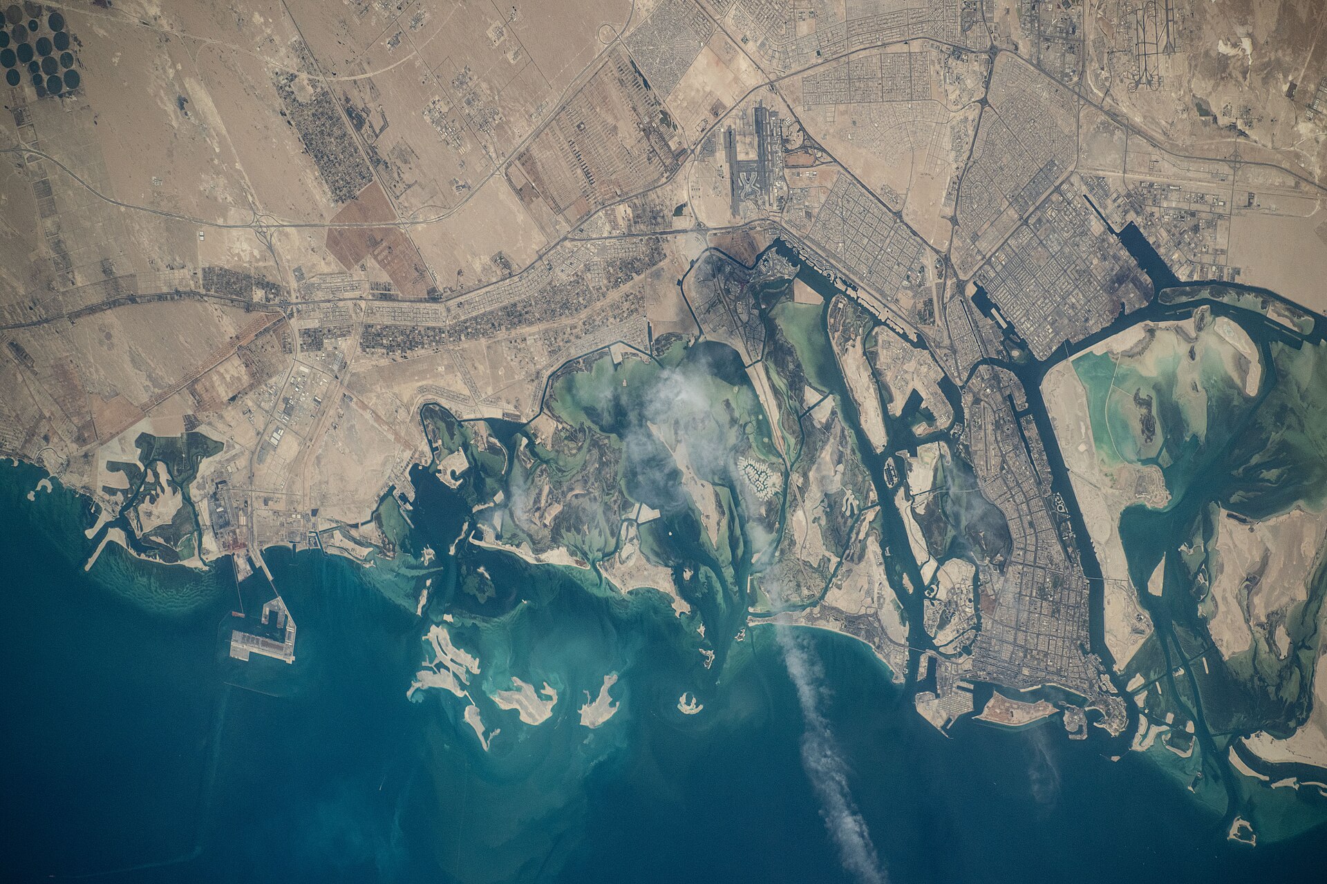 Abu Dhabi western industrial coastline photographed from the International Space Station showing port infrastructure and Persian Gulf coast