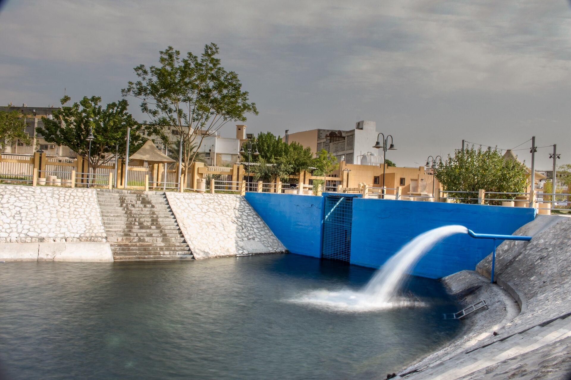 Ain al-Jawhariya natural spring in Al-Ahsa, Saudi Arabia, showing water flowing from a developed spring structure into a pool