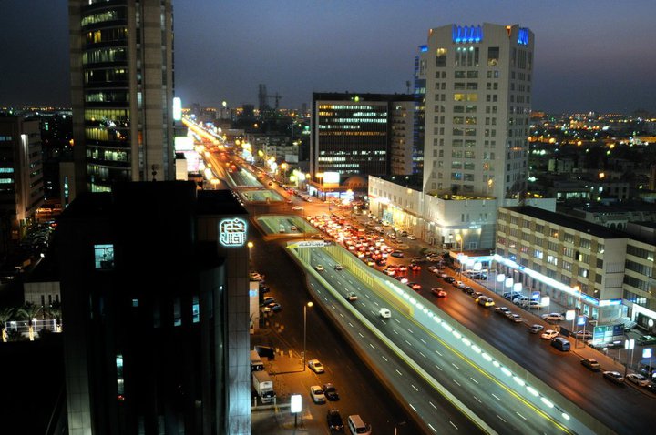 Aerial view of Al Khobar city at night, with illuminated buildings along the Arabian Gulf coastline