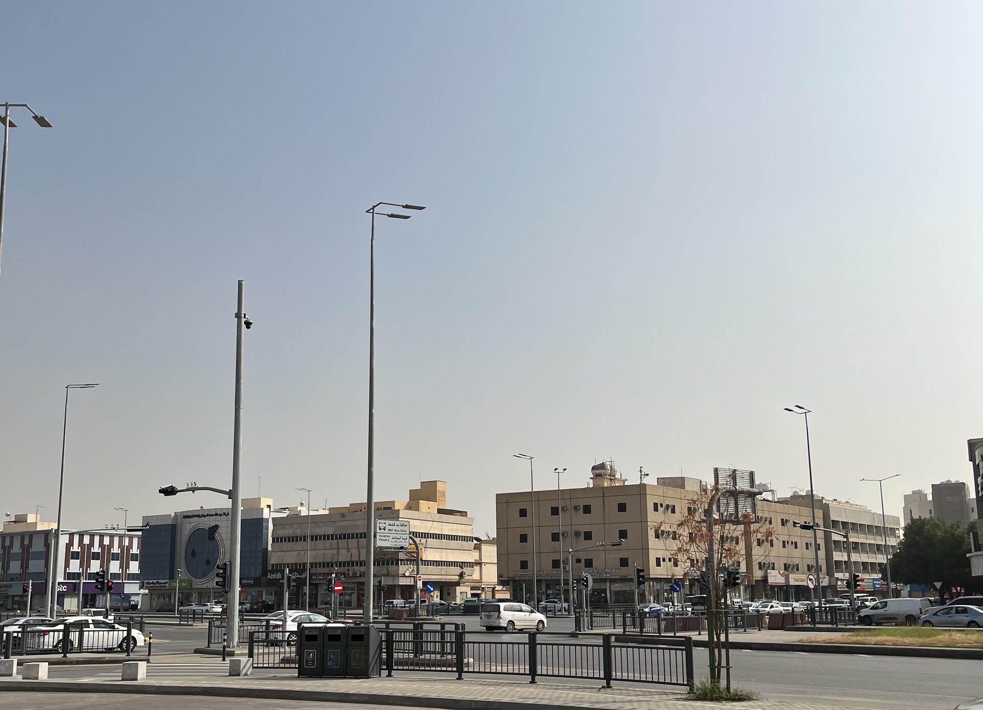 Street view of Al Malaz district in Riyadh showing mid-rise buildings, shops, and wide roads typical of the neighbourhood