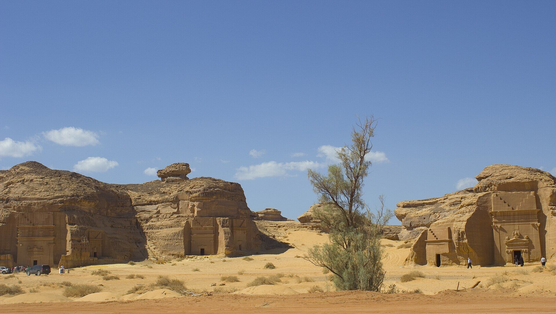 Nabataean rock-cut tombs at Hegra, AlUla, with ornate carved facades in golden sandstone