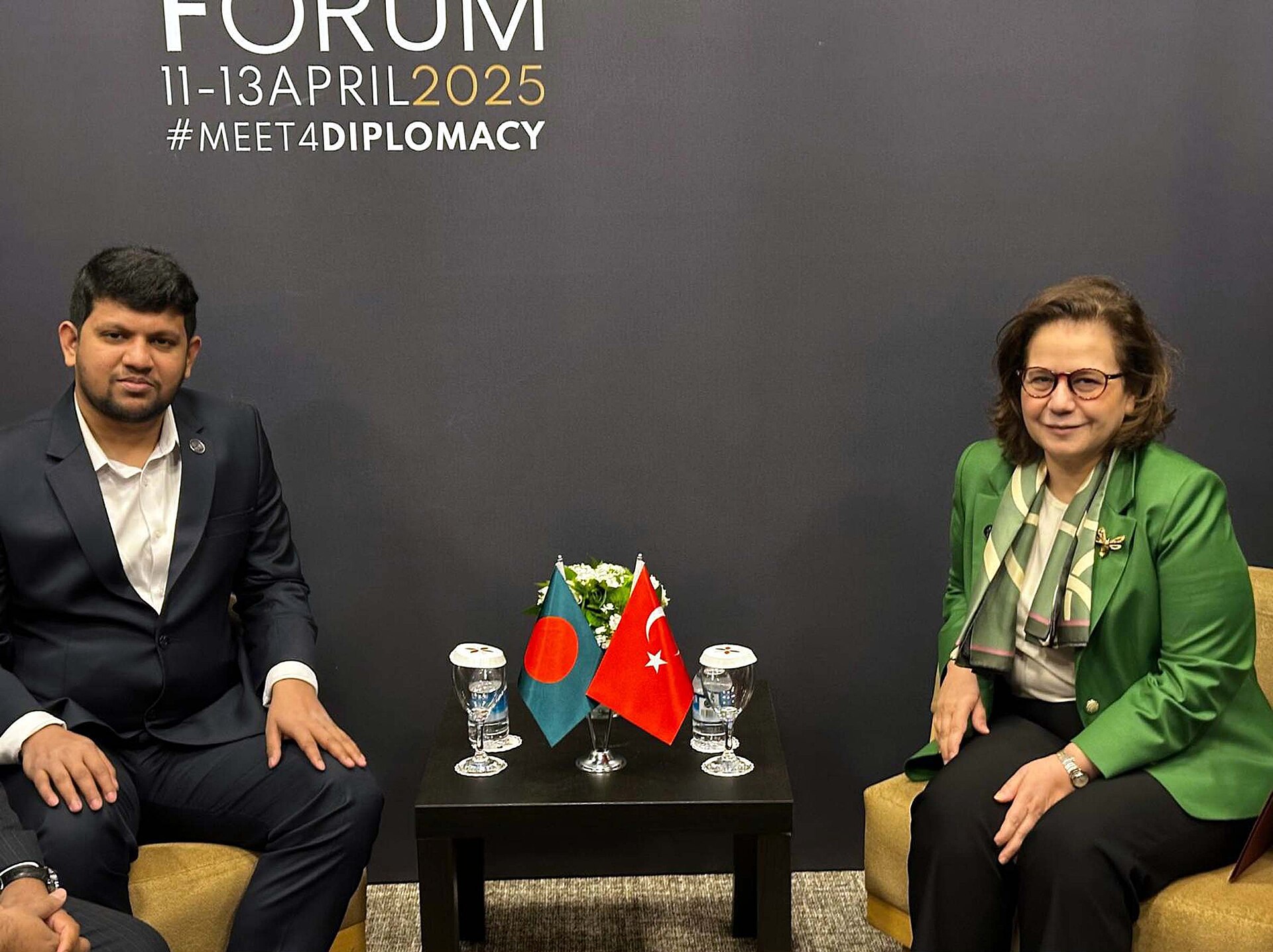 Turkey Deputy Foreign Minister Beris Ekenci in bilateral meeting at the Antalya Diplomacy Forum, April 2025, with Turkish flag and forum branding visible