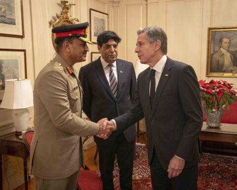 Pakistan Army Chief Field Marshal Asim Munir in military uniform shaking hands with US official at bilateral diplomatic meeting