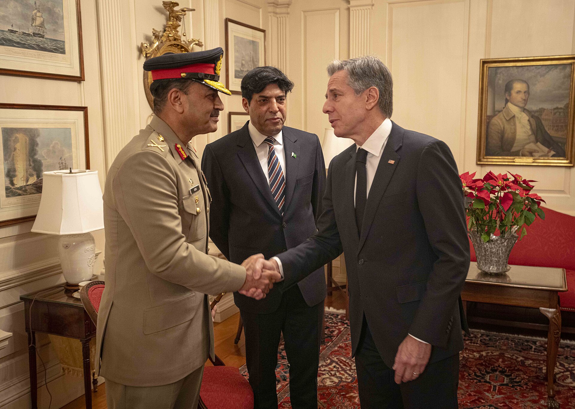 Pakistan Army Chief Field Marshal Asim Munir in military uniform shaking hands with US official at bilateral diplomatic meeting