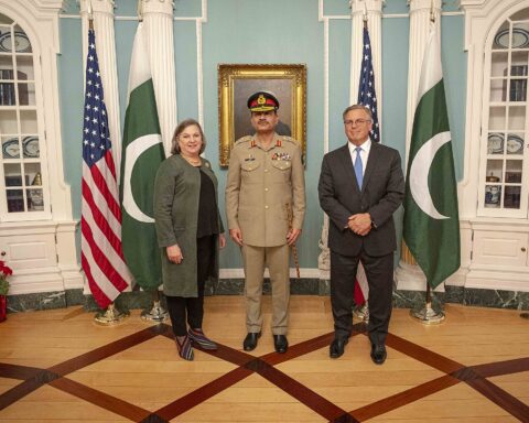 Pakistan Army Chief Asim Munir in military uniform with US Acting Deputy Secretary Victoria Nuland at the State Department, December 2023, with US and Pakistan flags