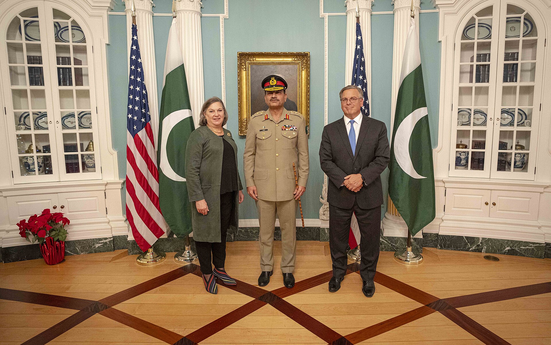 Pakistan Army Chief Asim Munir in military uniform with US Acting Deputy Secretary Victoria Nuland at the State Department, December 2023, with US and Pakistan flags