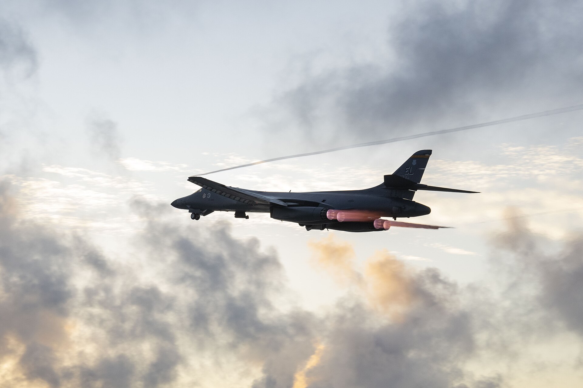 A B-1B Lancer strategic bomber with afterburners ignited during a Bomber Task Force sortie — the long-range platform central to the US campaign against Iranian infrastructure