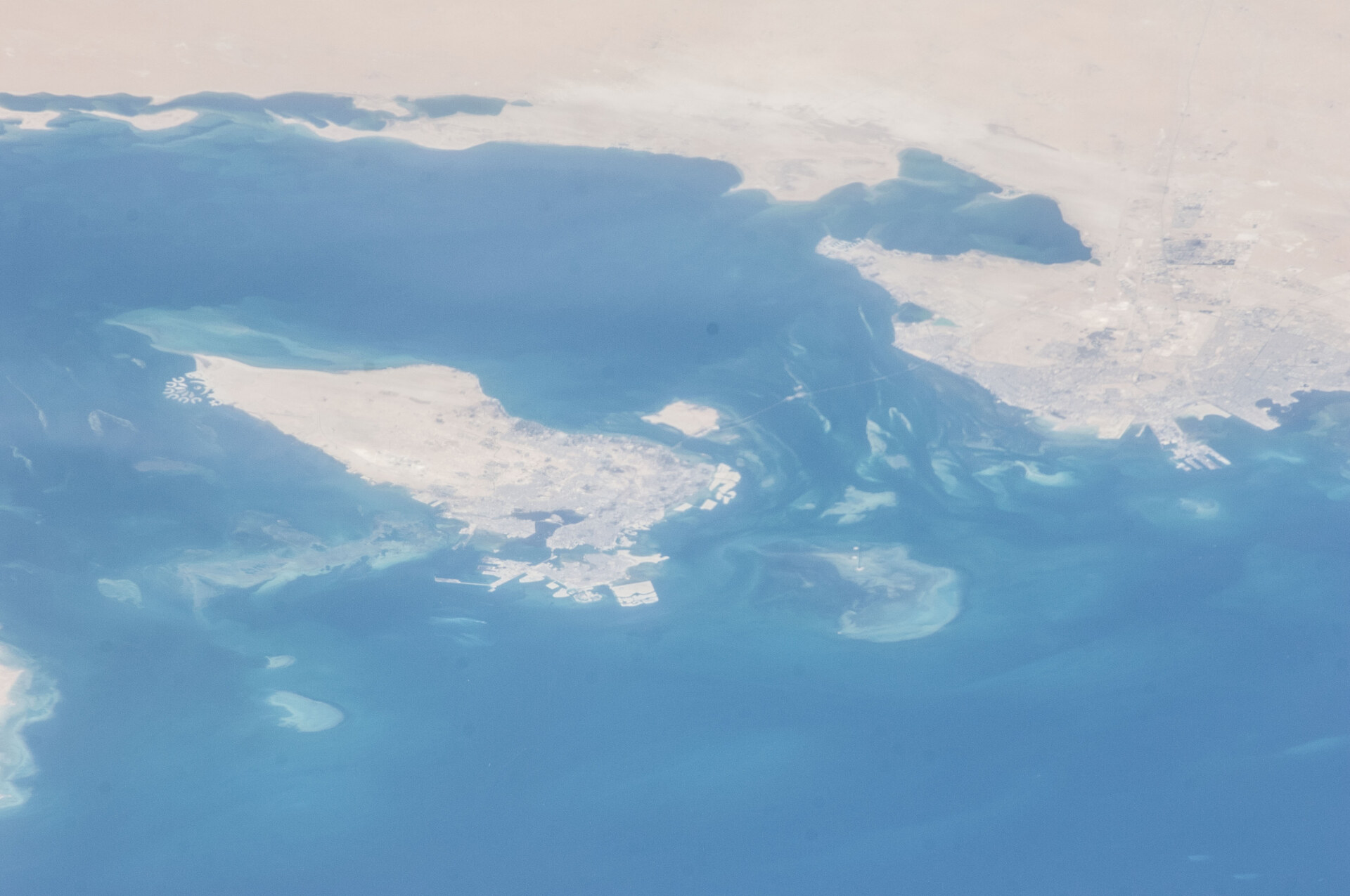 Bahrain island and Sitra industrial area viewed from the International Space Station, showing the Persian Gulf geography surrounding the Bapco refinery complex
