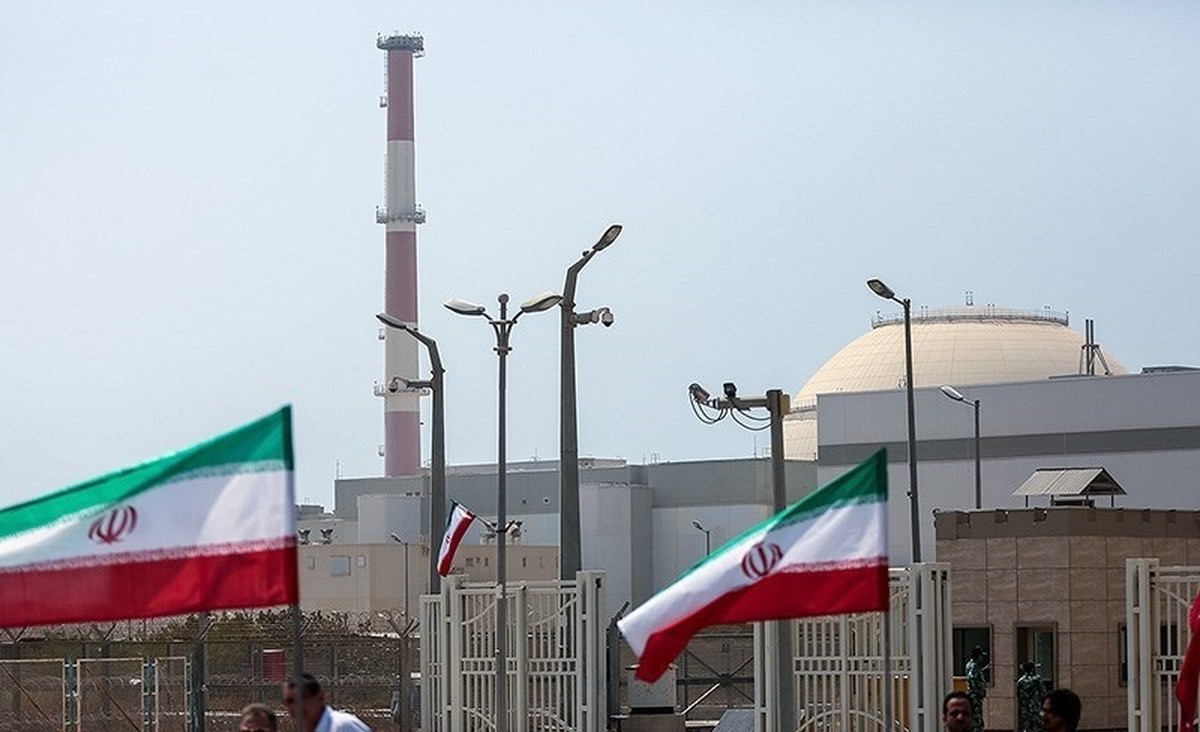 Bushehr Nuclear Power Plant reactor containment dome and security gate with Iranian flags at the second-phase groundbreaking ceremony, 2015