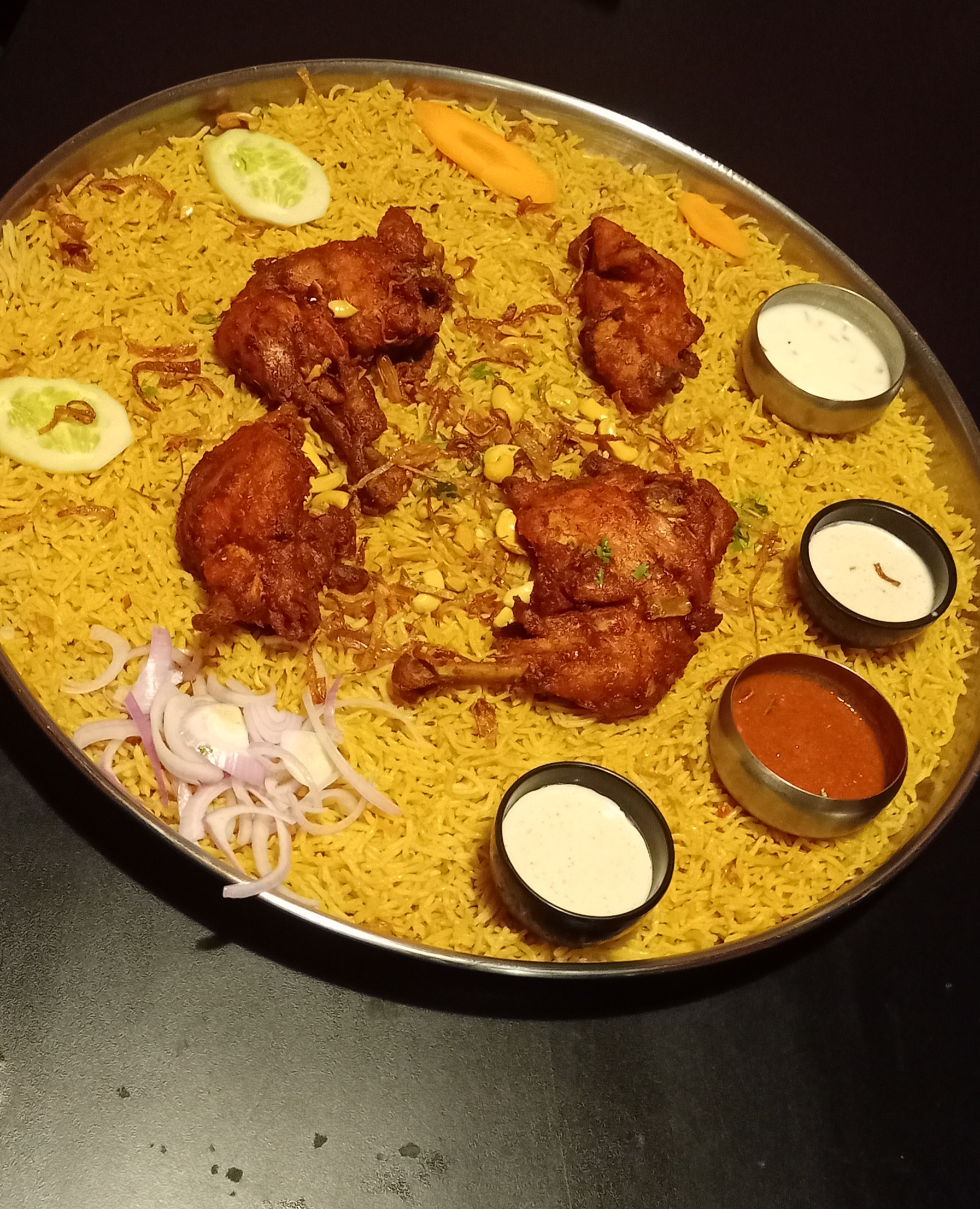 Chicken mandi platter with basmati rice, sauces and fried chicken pieces