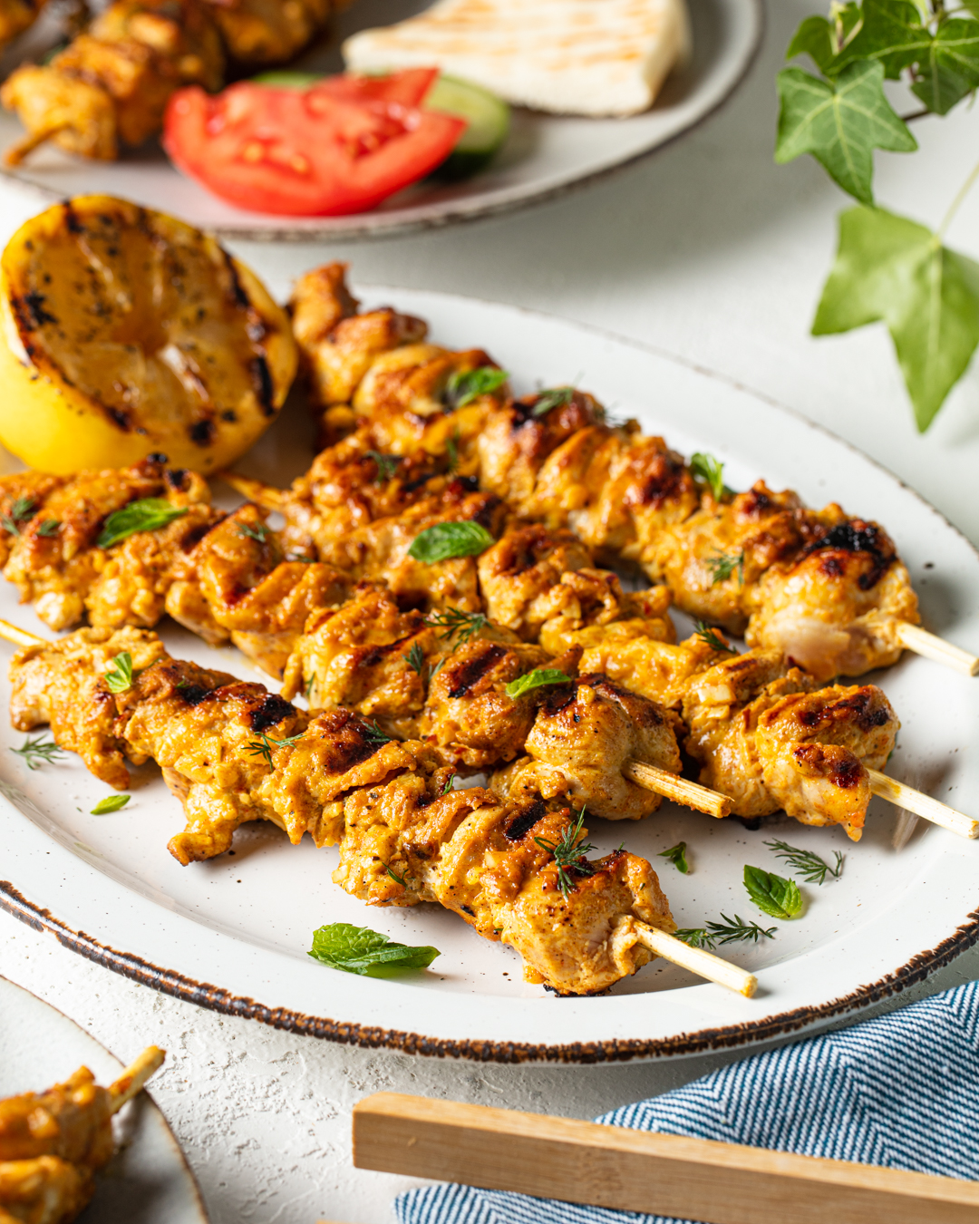 Chicken shawarma skewers with herbs and grilled lemon
