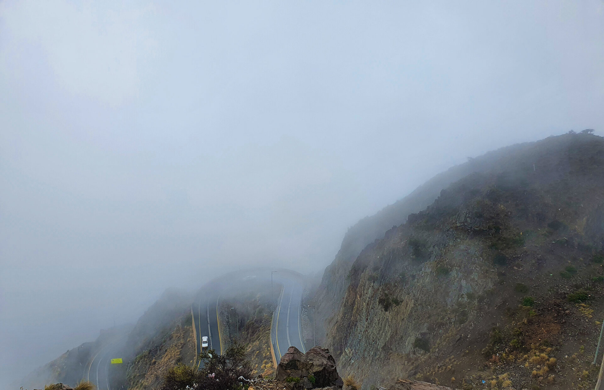 Winding mountain road through the Sarawat Mountains in the Asir region of Saudi Arabia, shrouded in mist