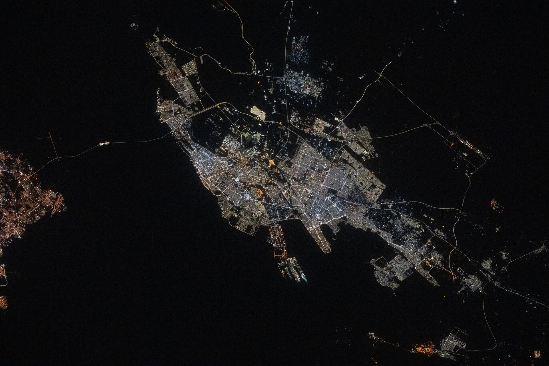 Dammam metropolitan area at night seen from the International Space Station, showing the city lights along the Gulf coast