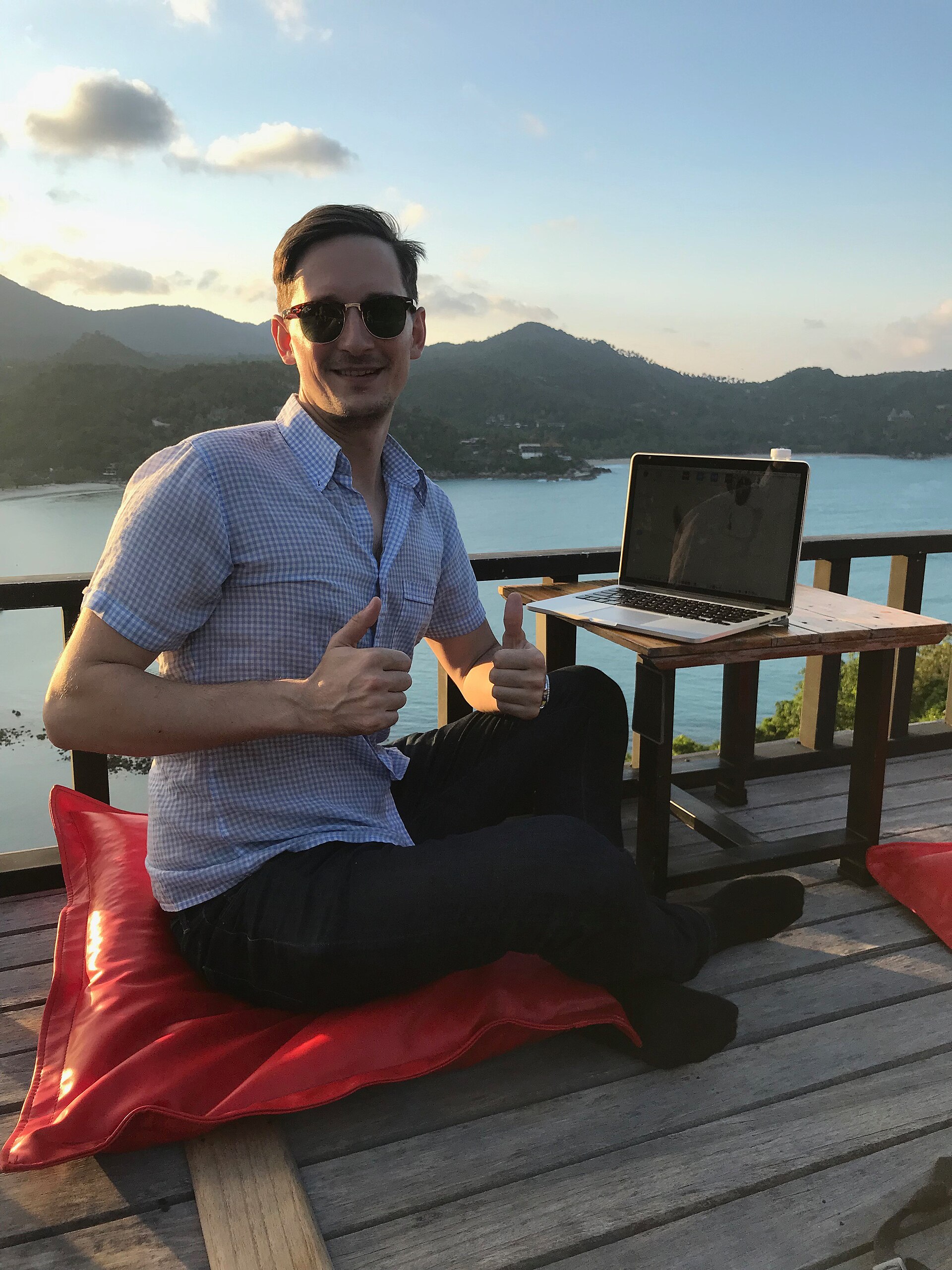 Digital nomad working remotely on a laptop with a scenic view