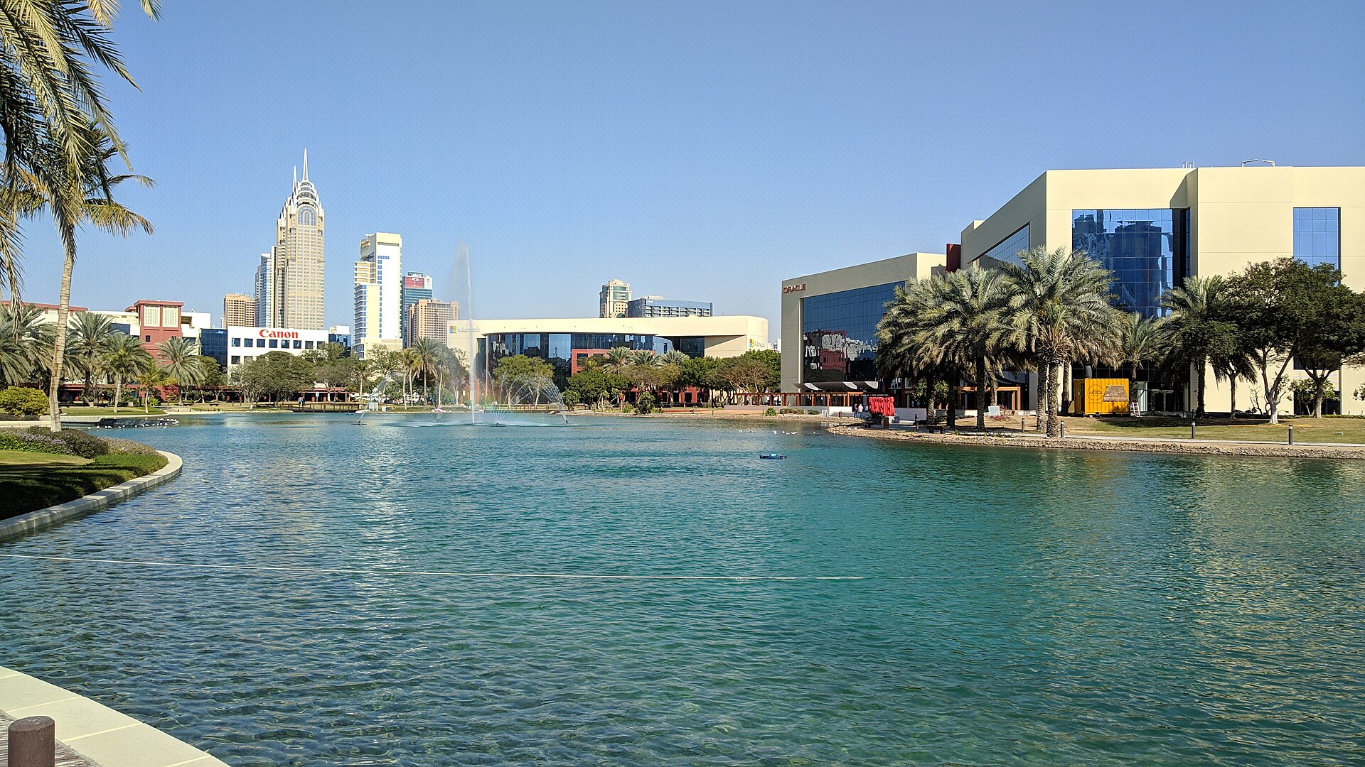 Dubai Internet City tech campus — Canon, IBM, and other multinational technology companies surround the central lake and amphitheater at Dubai Internet City, where Oracle maintains UAE cloud infrastructure targeted by IRGC claims