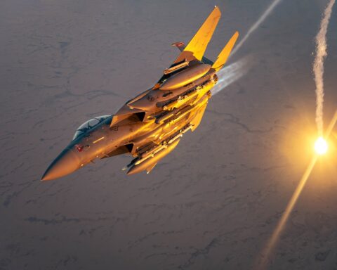 USAF F-15E Strike Eagle performs flare check over desert, March 2025 — the same aircraft type downed over Iran on April 3, 2026, triggering a 155-aircraft rescue mission