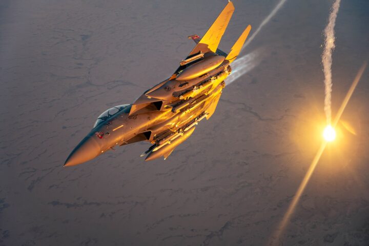 USAF F-15E Strike Eagle performs flare check over desert, March 2025 — the same aircraft type downed over Iran on April 3, 2026, triggering a 155-aircraft rescue mission