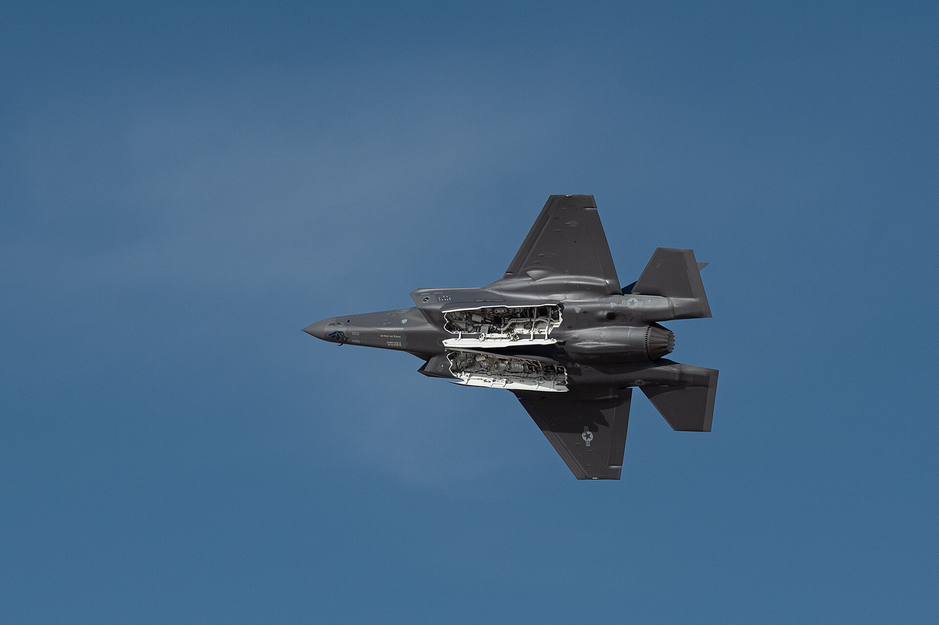 USAF F-35A Lightning II performs flying display at Dubai Airshow 2023, weapons bay open in flight over UAE