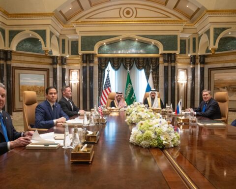 Saudi Foreign Minister Prince Faisal bin Farhan al-Saud at the head of the diplomatic table at Diriyah Palace, Riyadh, flanked by US Secretary of State Rubio and Russian foreign policy advisor Ushakov, February 2025