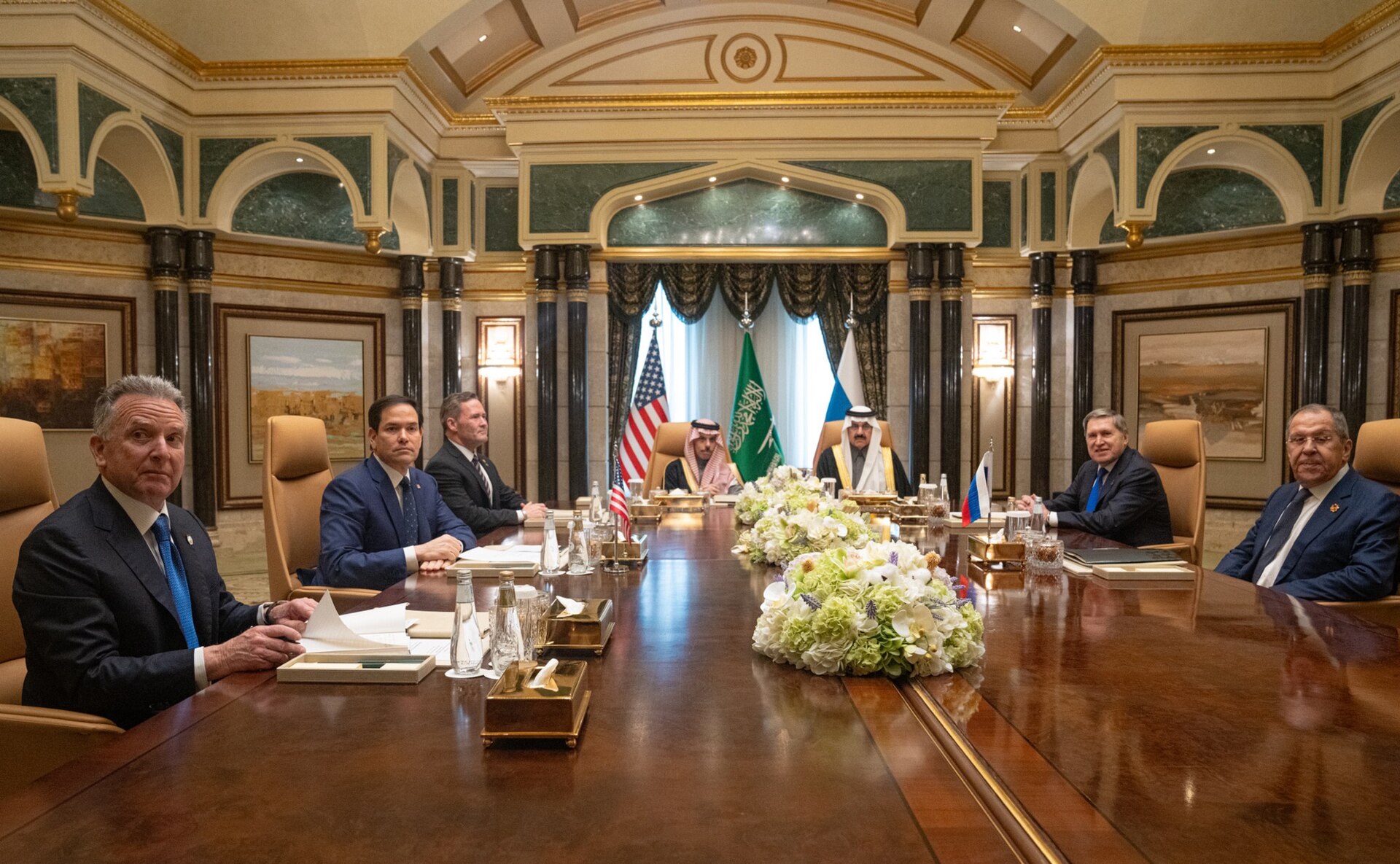Saudi Foreign Minister Prince Faisal bin Farhan al-Saud at the head of the diplomatic table at Diriyah Palace, Riyadh, flanked by US Secretary of State Rubio and Russian foreign policy advisor Ushakov, February 2025