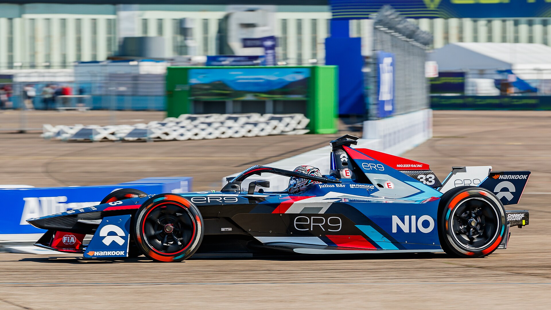 A Formula E Gen3 electric racing car at speed on a street circuit