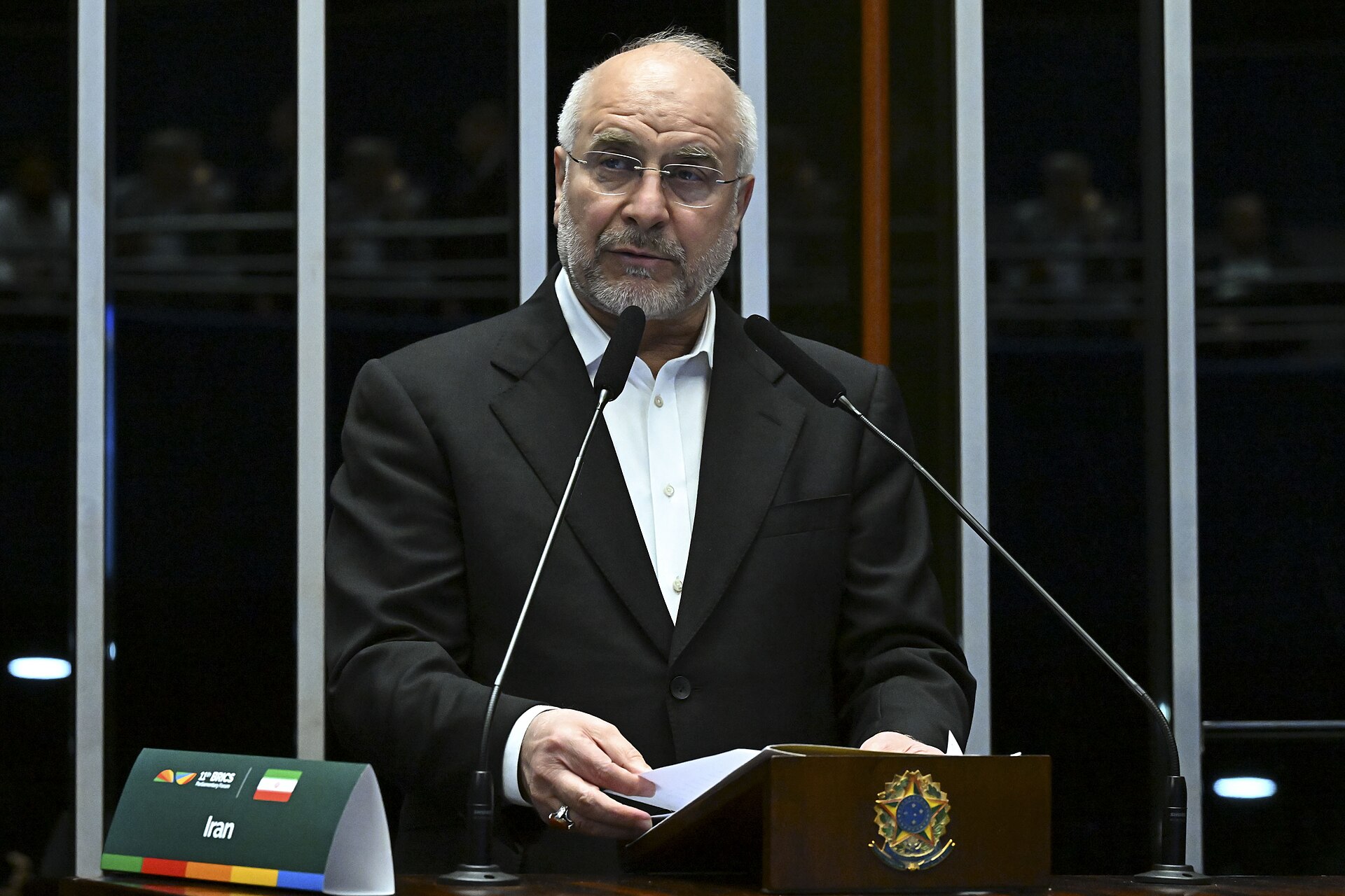 Mohammad Bagher Ghalibaf, Speaker of Iran's Islamic Consultative Assembly, speaking at podium at BRICS Parliamentary Forum 2025, with Iranian flag nameplate visible
