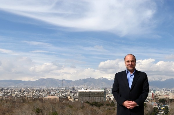 Mohammad Bagher Ghalibaf, Iran Parliament Speaker and SNSC permanent member, with Tehran skyline in background — the figure whose April 19 2026 reciprocity doctrine converted Hormuz closure from IRGC operational posture into formal precondition