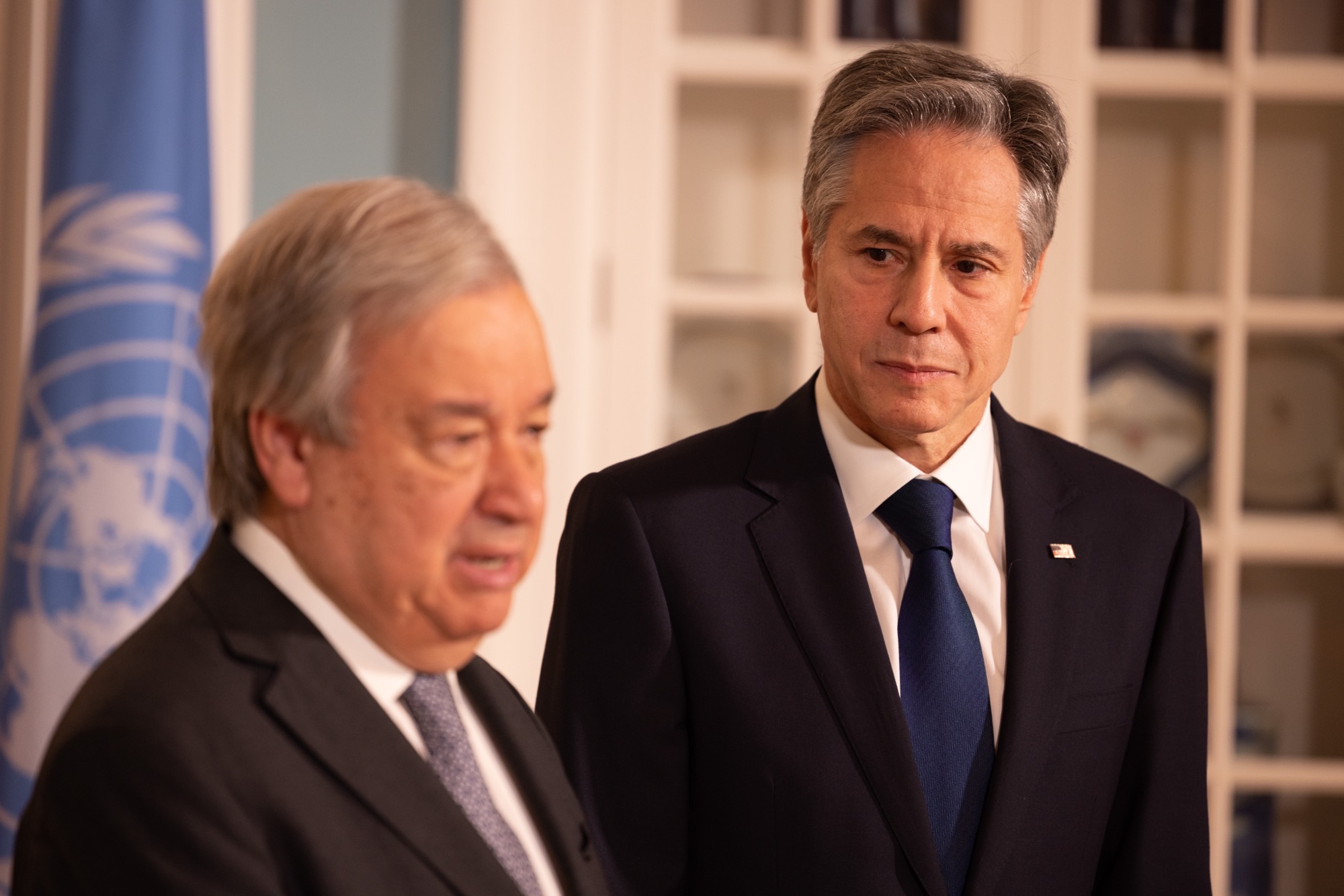 UN Secretary-General António Guterres speaking before the United Nations flag at a bilateral diplomatic meeting
