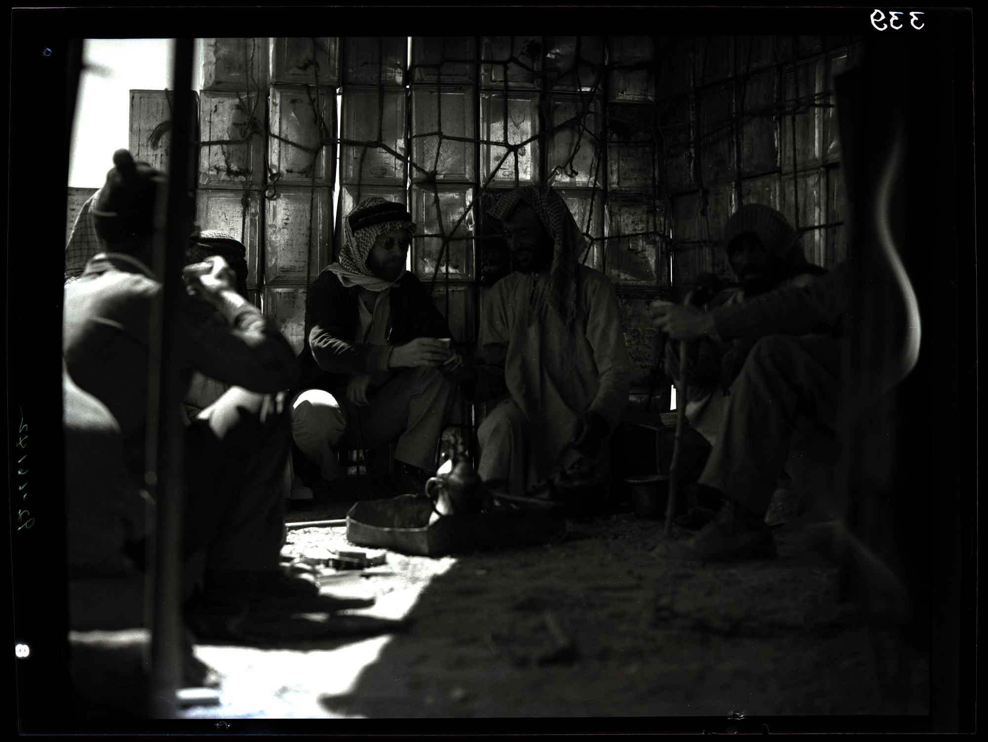 Bedouin men gathered in Hafar Al-Batin during the 1935 CASOC oil expedition to Saudi Arabia