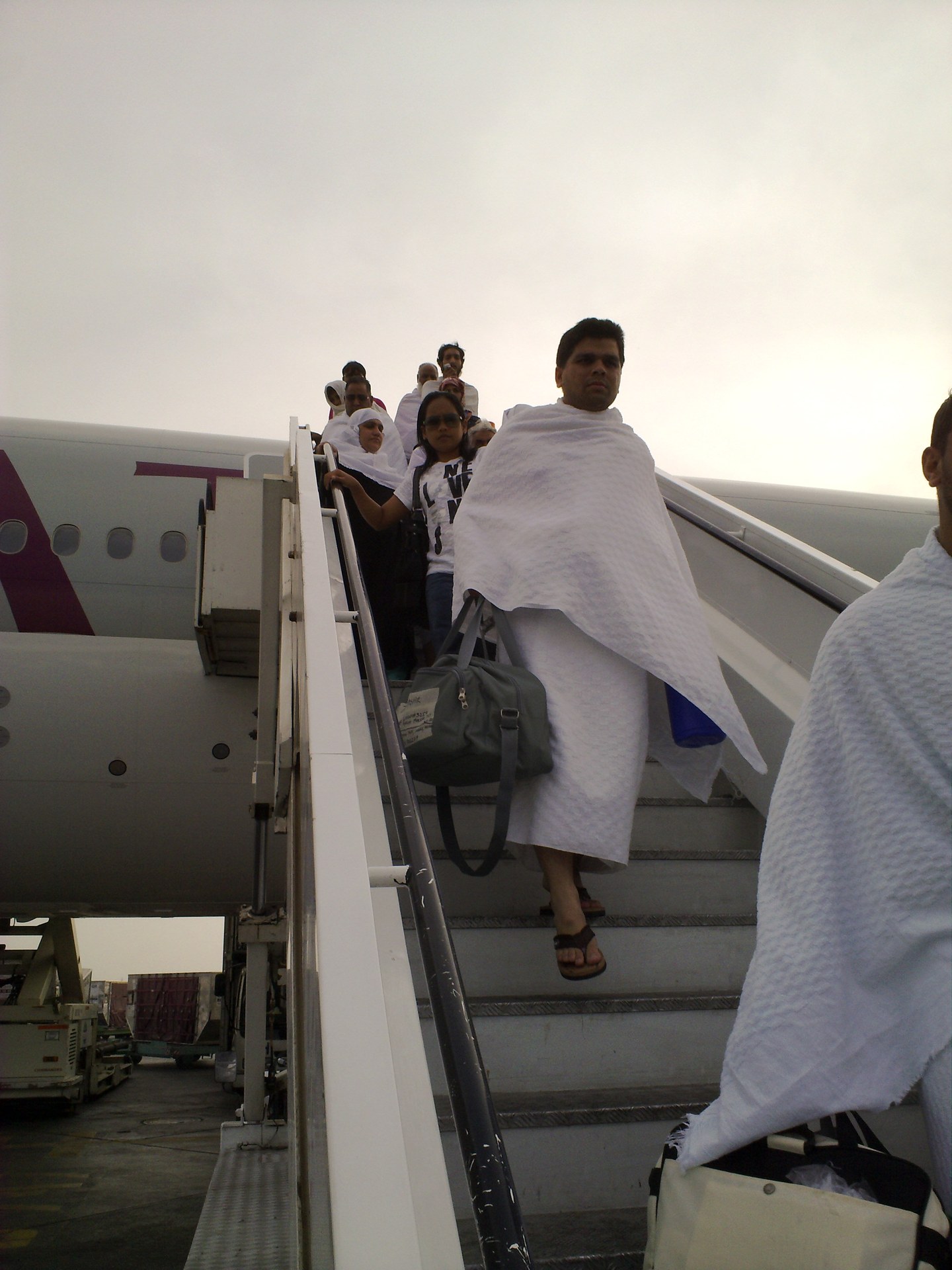 Hajj pilgrims wearing ihram garments disembark aircraft at King Abdulaziz International Airport in Jeddah, Saudi Arabia, November 2009