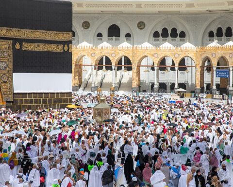 Pilgrims circumambulate the Kaaba at Masjid al-Haram during Hajj 2025, with hundreds of thousands of worshippers in white ihram filling the courtyard