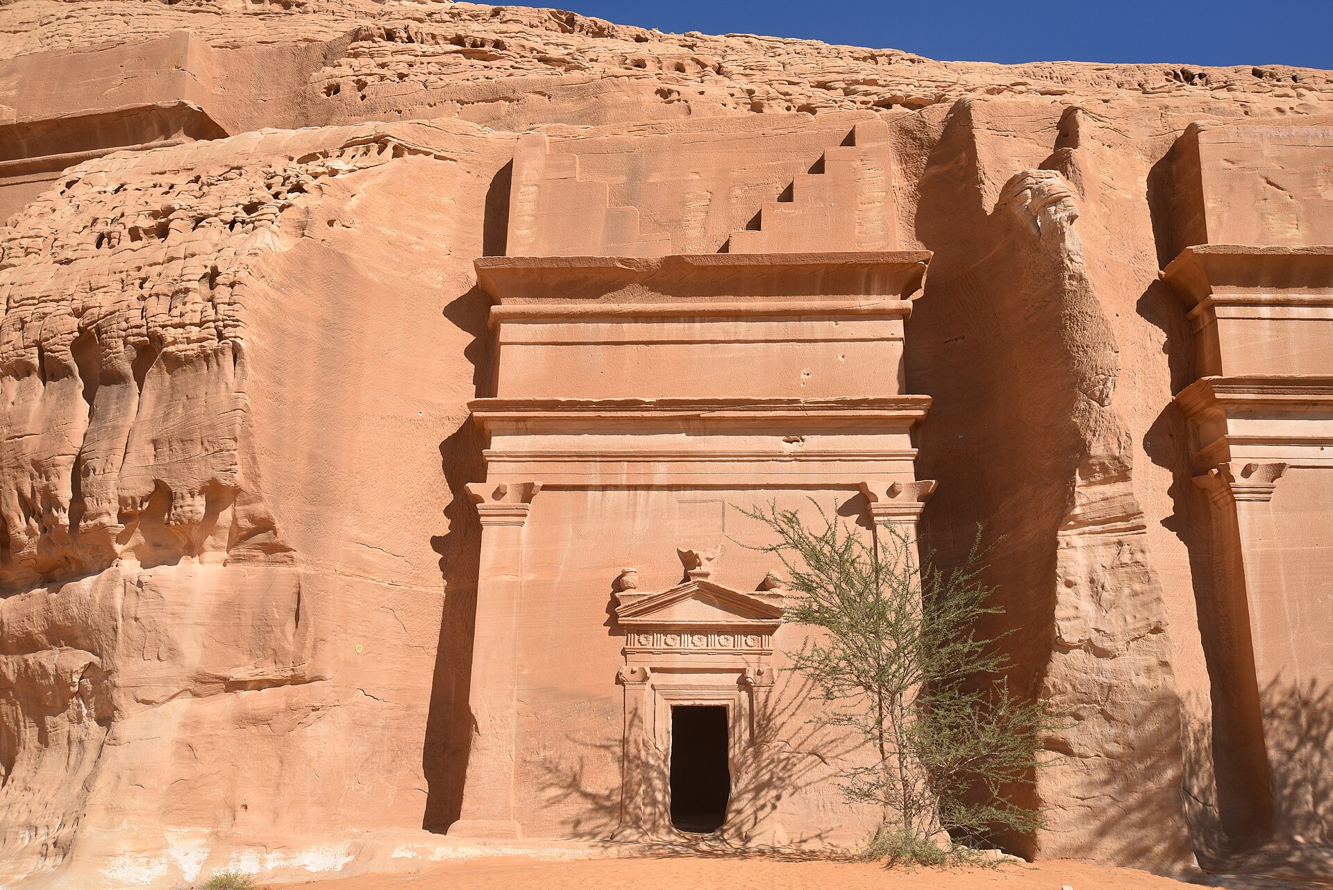 Nabataean rock-cut tomb at Hegra (Mada'in Salih) in AlUla, Saudi Arabia, showing intricate carved facade in sandstone cliff